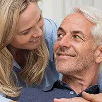 Smiling older couple looking at each other warmly, representing customer testimonials for Vision 20 supplement.